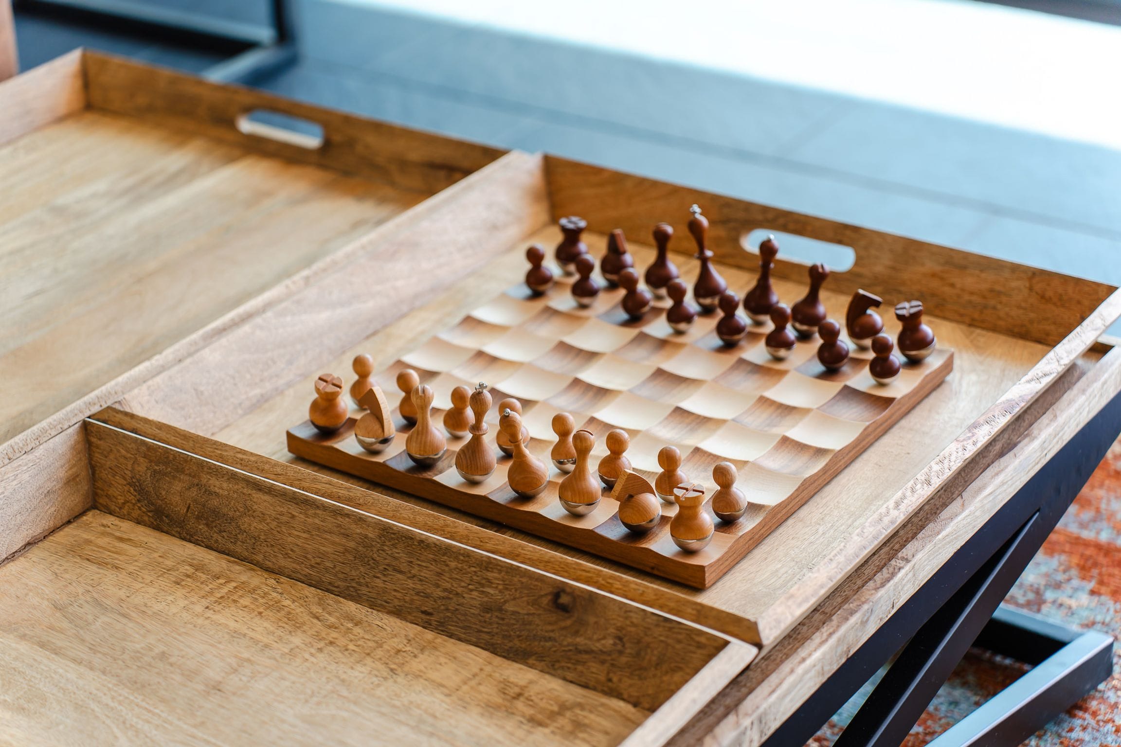 Wooden chess set on a timber tray table